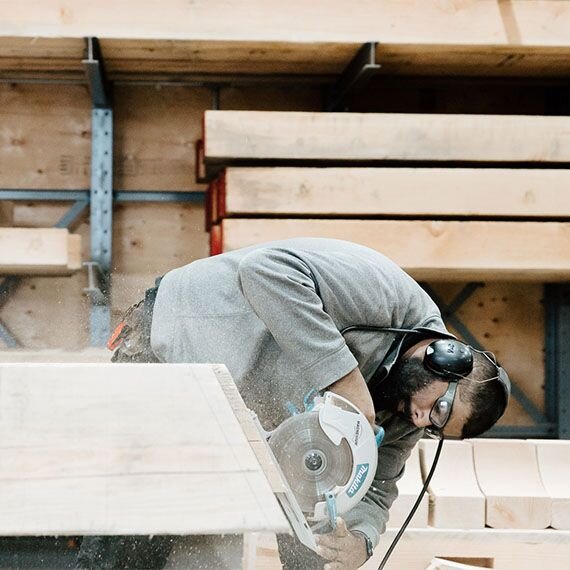 Craftsman using hand saw